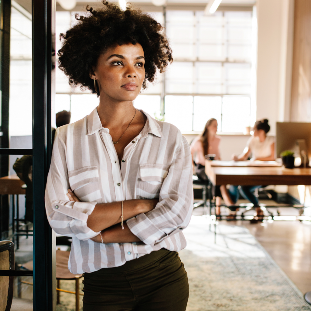 Black woman in corporate setting wondering how to manage work stress