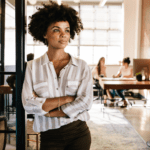 Black woman in corporate setting wondering how to manage work stress