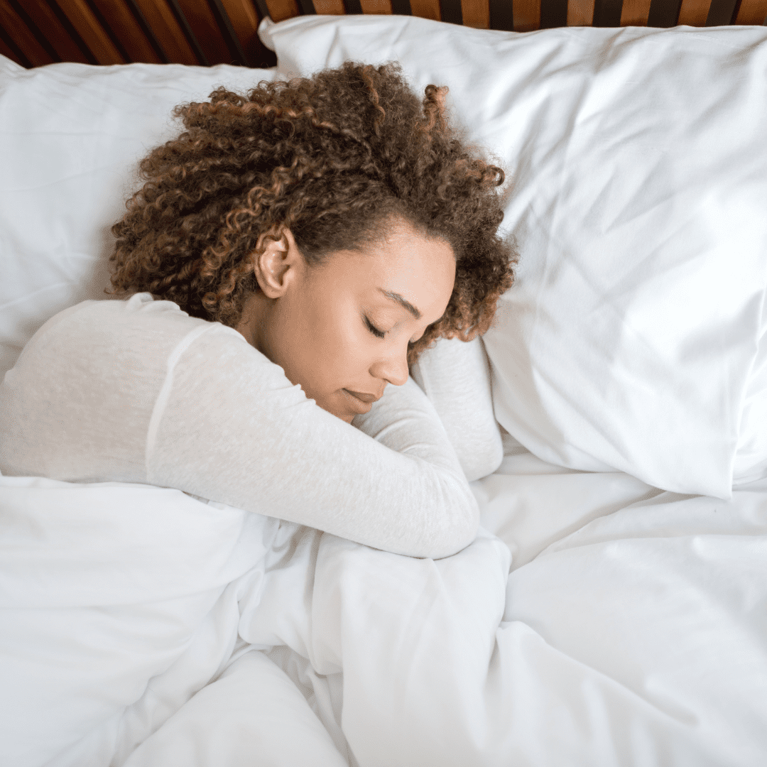 Black woman lying in bed sleeping | meditation for sleep