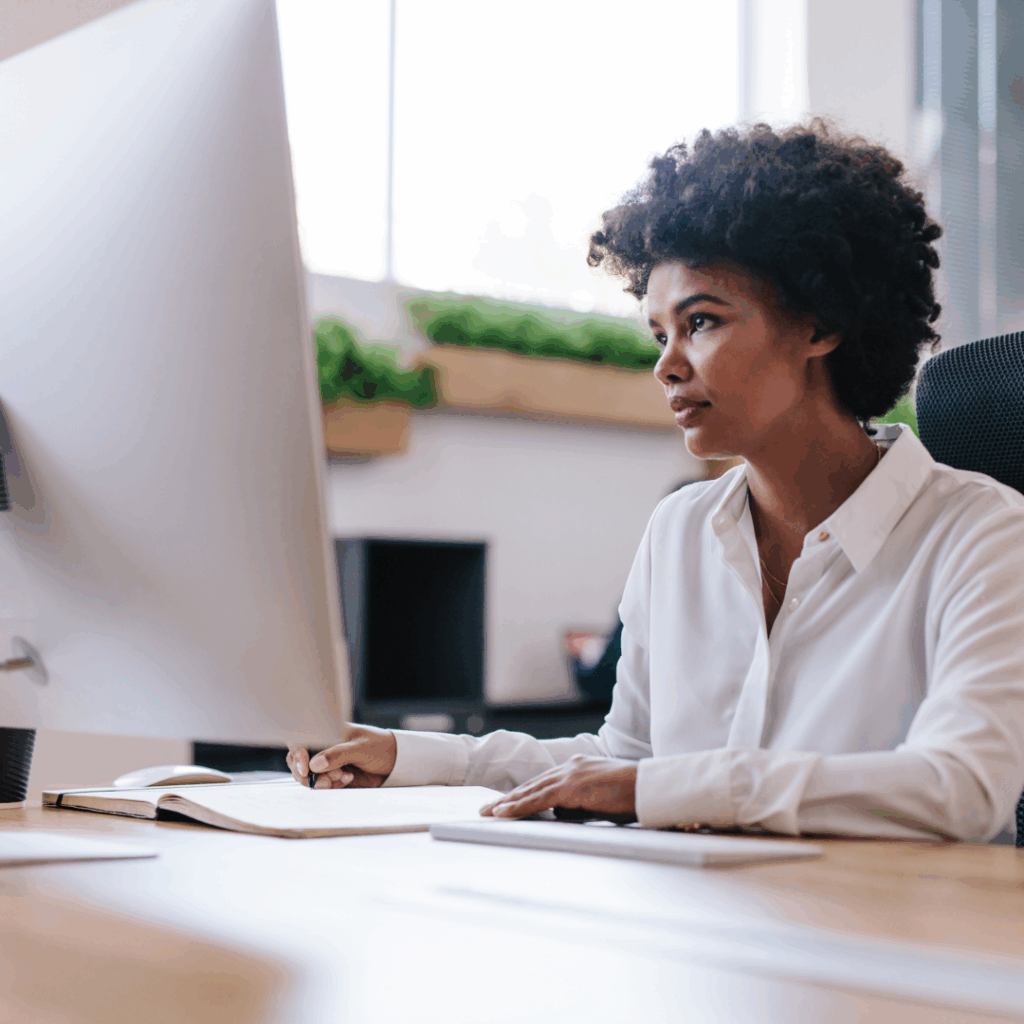 Black woman sitting at computer with a frustrated look | Dealing with a toxic boss