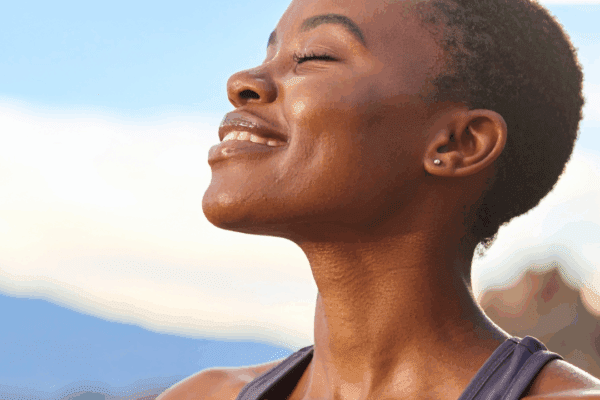 Black woman smiling outdoors | How to process emotions