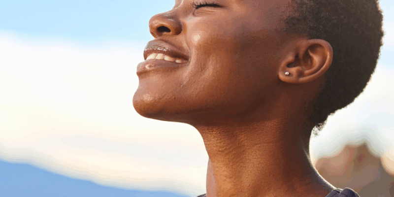 Black woman smiling outdoors | How to process emotions