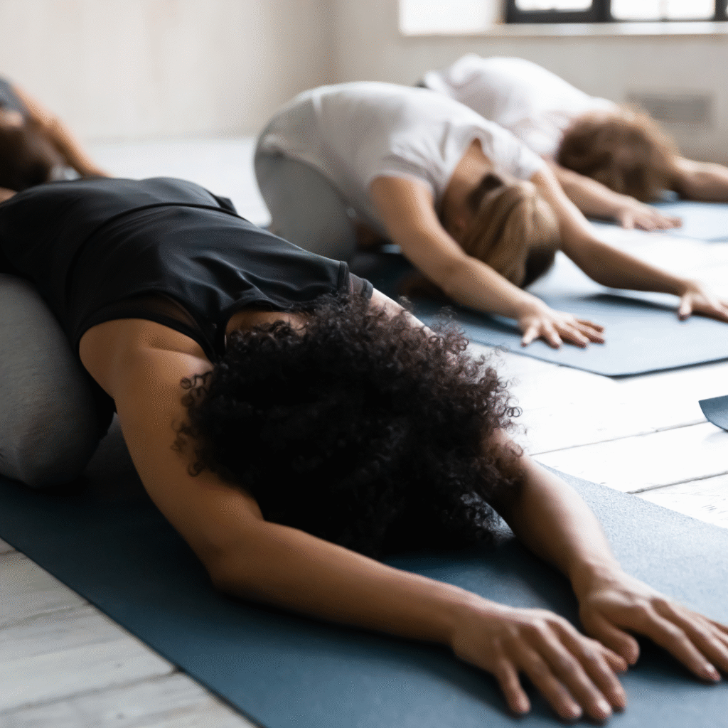 Black woman stretching in child's pose | how to release emotional tension in the body