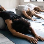 Black woman stretching in child's pose | how to release emotional tension in the body