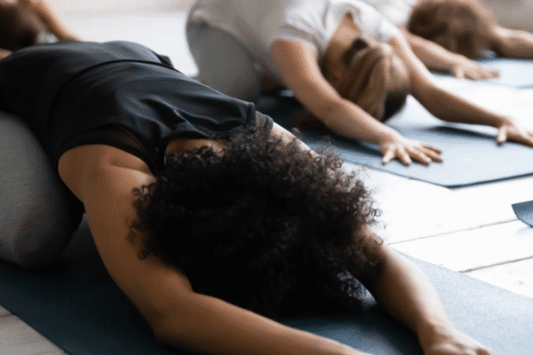 Black woman stretching in child's pose | how to release emotional tension in the body