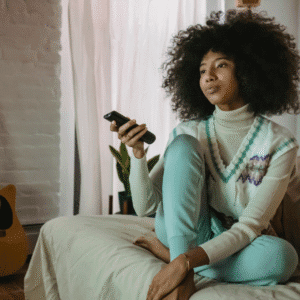 Young Black woman looking disinterested flipping through the tv channels | Why you may shut down emotionally