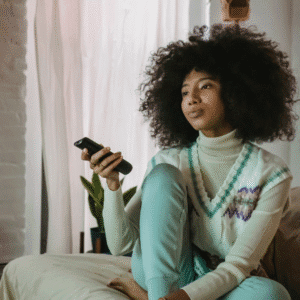 Young Black woman looking disinterested flipping through the tv channels | Why you may shut down emotionally